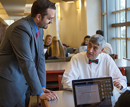 Law professor with student in library