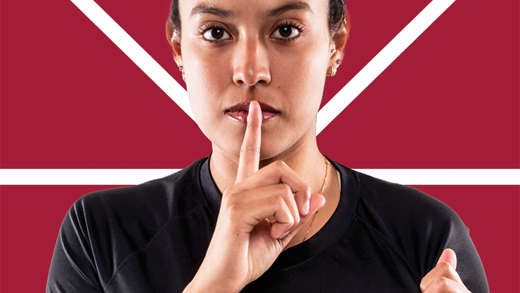 Woman holding finger over mouth