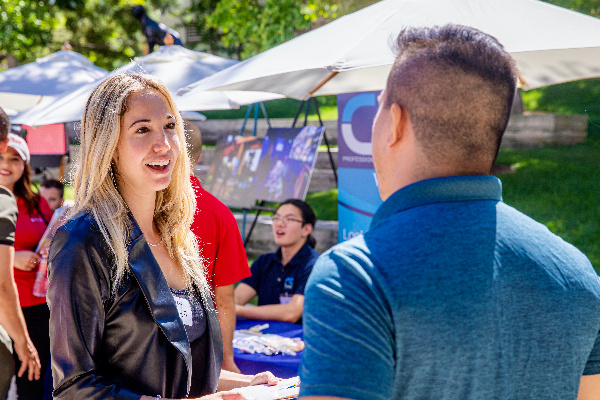 Student talking with staff member. 