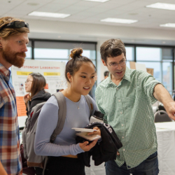 Faculty members point to show student project