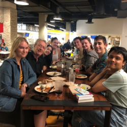 Students and professors eat lunch at cafeteria table together