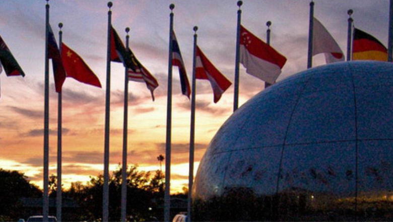 international flags with a sunset backdrop