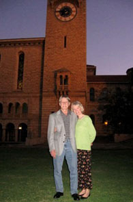 Couple standing in front of a tall building.