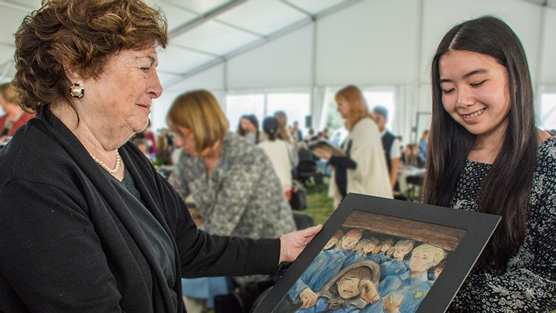 Holocaust survivor looks at artwork student created based on her video testimony