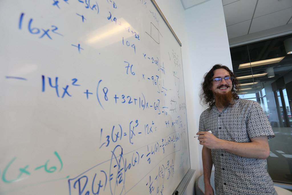 A student demonstrating a math problem on a whiteboard