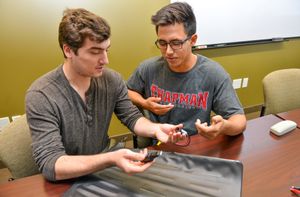 Two students work in a psychology lab.