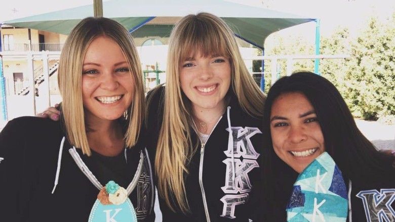 three sorority sisters smiling at camera