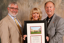 Three people and a framed image