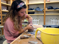 person working with clay