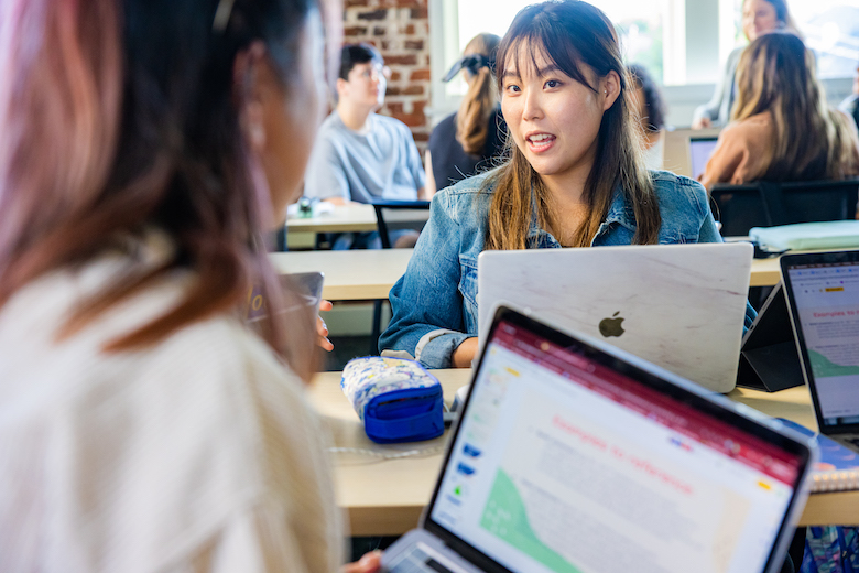 Wilkinson College student in group discussion with classmate