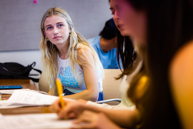 Wilkinson College student listening intently to classmate